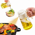 2-in-1 glass oil sprayer and dispenser bottle spraying oil on BBQ and pouring oil over salad